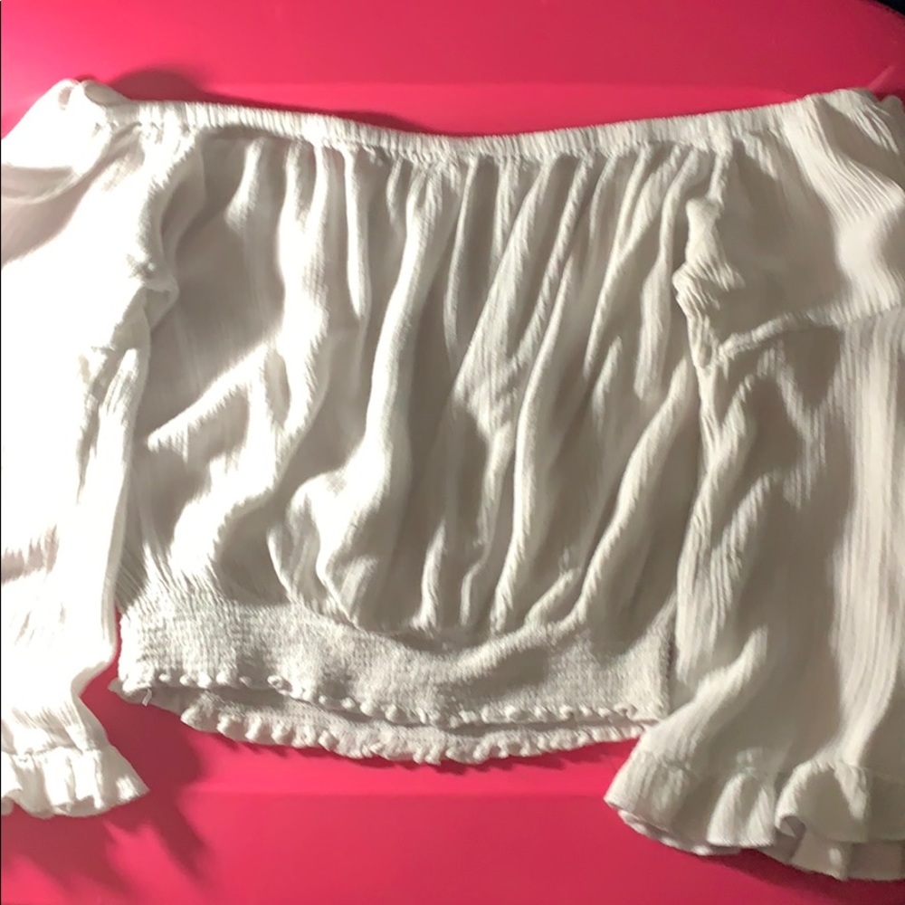 •a cropped off the shoulder ruffle shirt